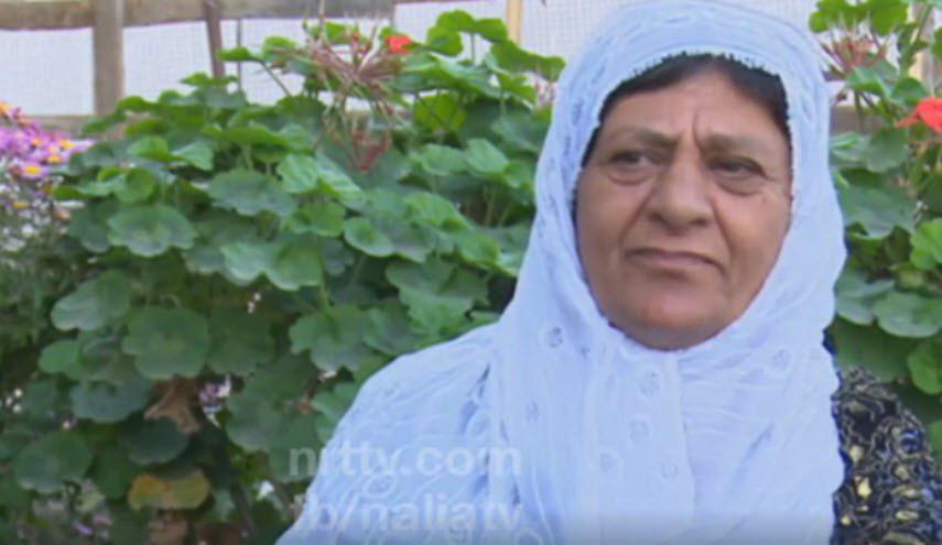 بالصور... مسنّة عراقية تشجع ريال مدريد على طريقتها