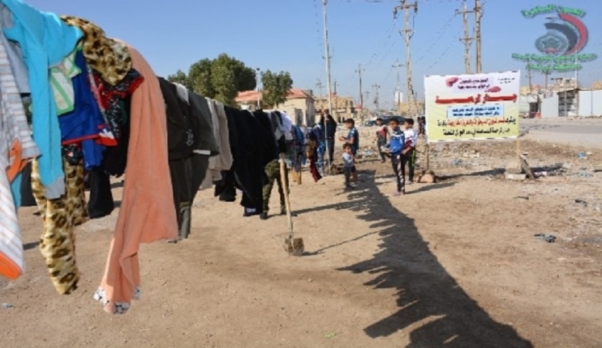 بالصور.. شرطة ذي قار تبني جدار الرحمة